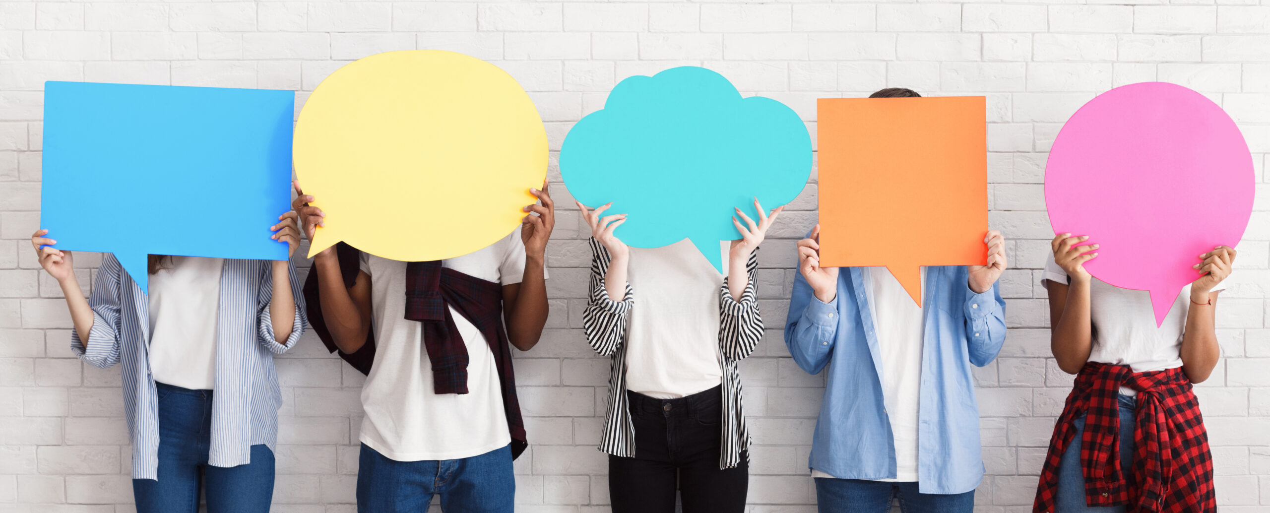 Teenagers holding speech bubbles with copy space