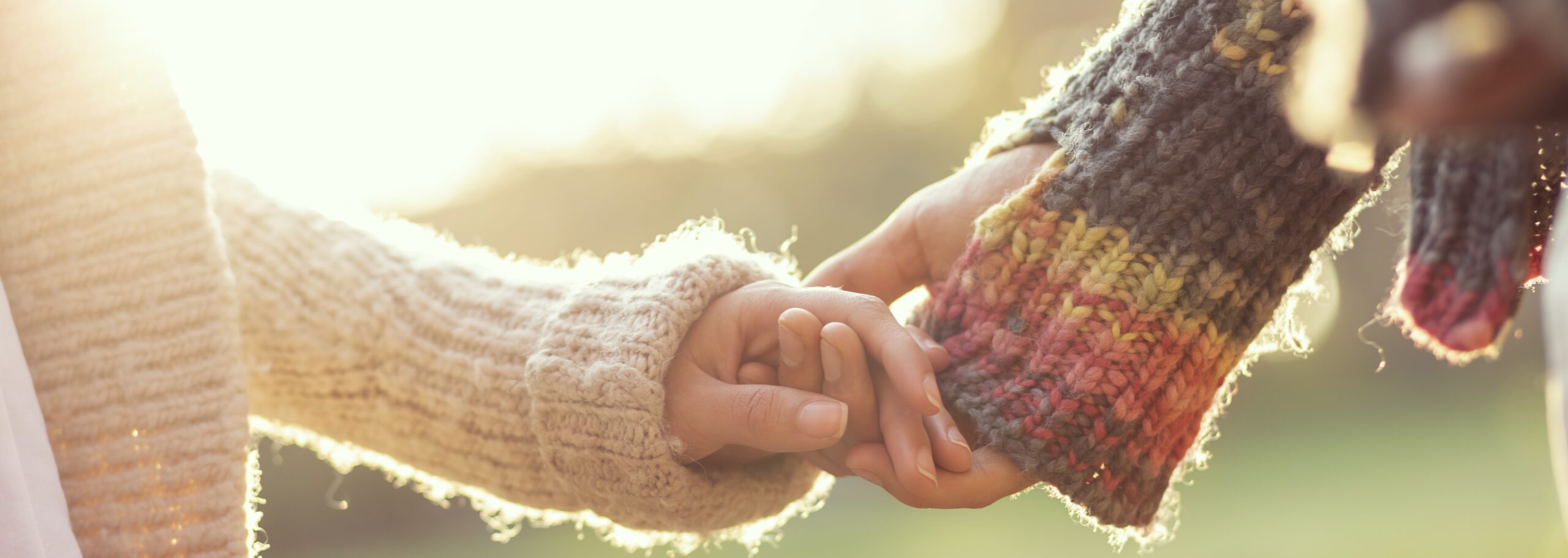 Detail of couple holding hands